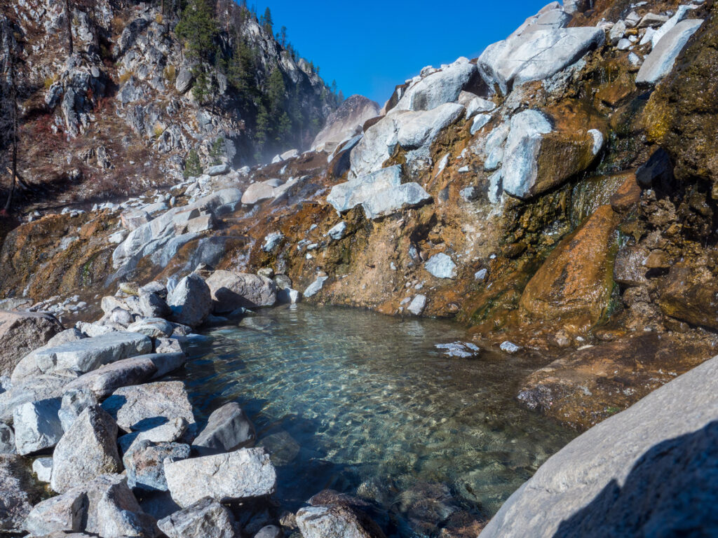 Hot Spring in Idaho with steam billowing during the morning on a clear day