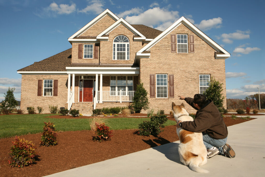 Man showing his dog their new home. Please view these and all pictures of other houses in my portfolio.