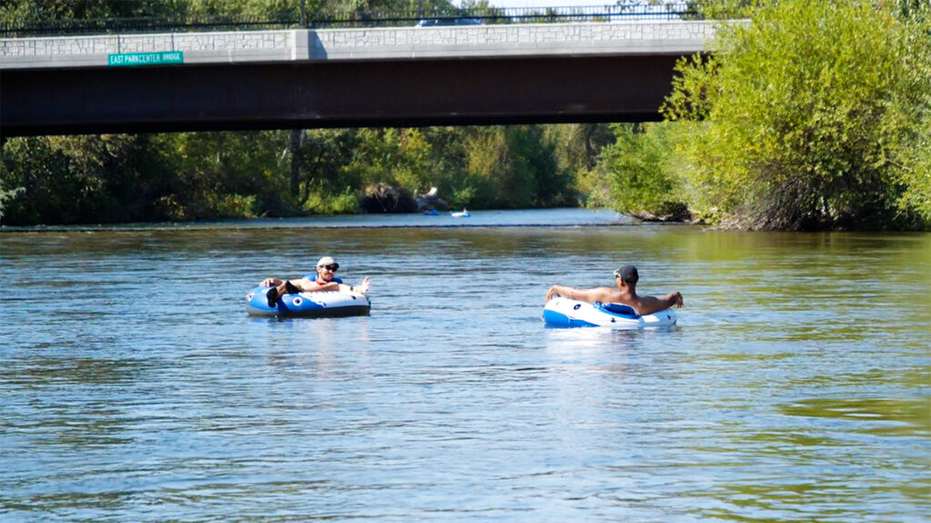 two people casually floating the boise river