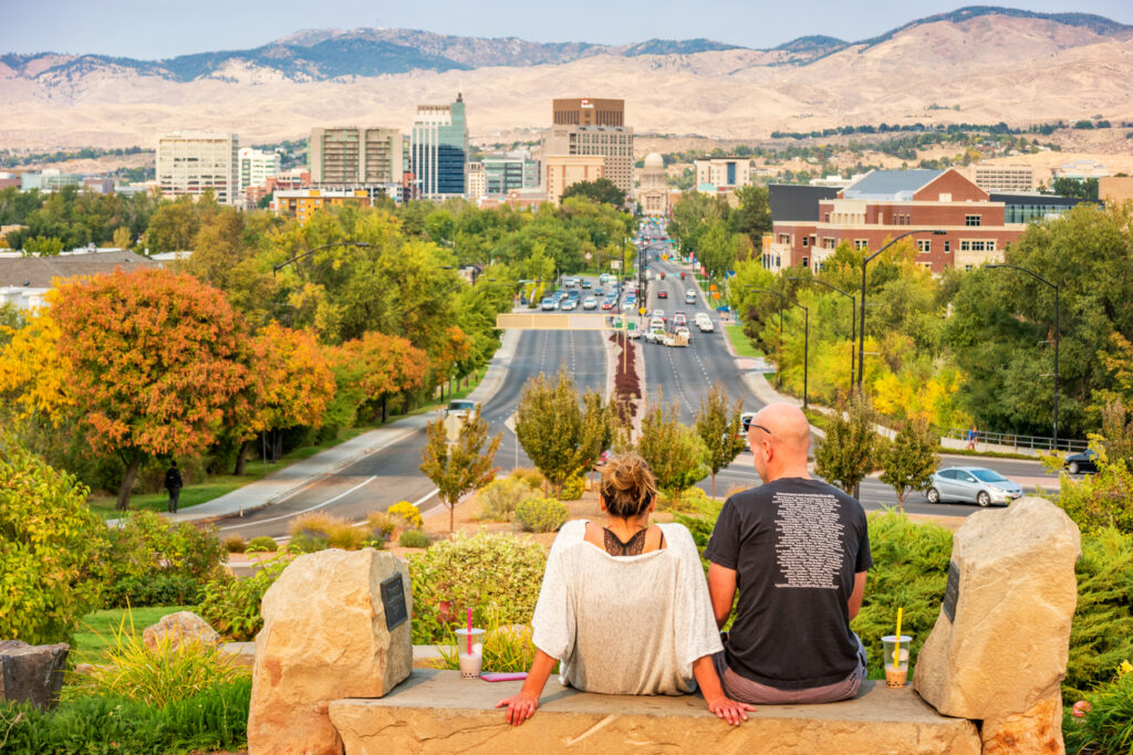 Couple sits on a bench at the Boise Depot in downtown Boise Idaho USA on a sunny day.